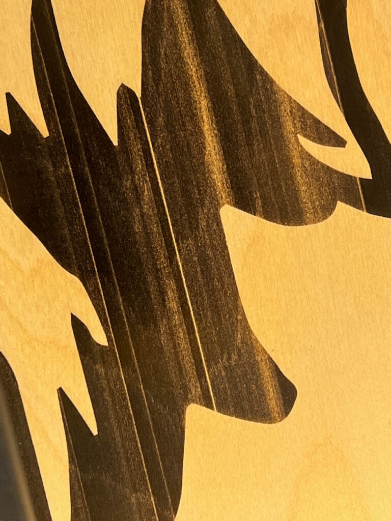 close up of borax method on corn hole boards and banding lines created from the laser not being a high enough power