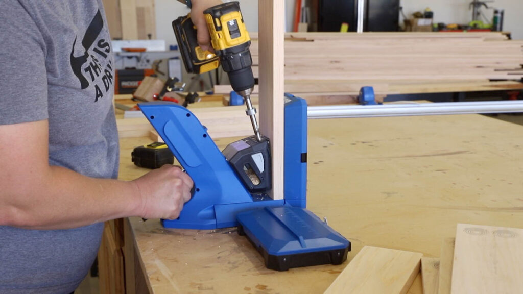 Using the Kreg Jig 720PRO to drill pocket holes into a pine board for cornhole frame assembly