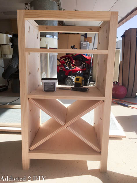 Unfinished DIY wine cabinet with X wine rack and shelves fully assembled, no trim or finish applied yet