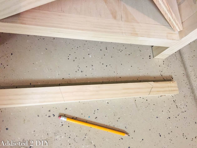 1x2 pine trim piece lying flat with pencil angle marks to indicate the miter cut needed to frame the X wine rack