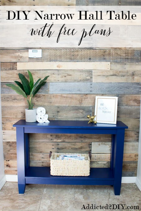 DIY narrow hallway table in navy blue against a pallet accent wall, with text overlay reading "DIY Narrow Hall Table with free plans"