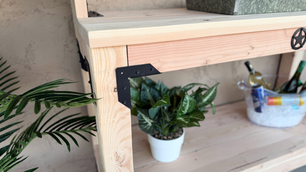 Detail of the black Simpson Strong-Tie angle connector and decorative star accent on the finished console table corner