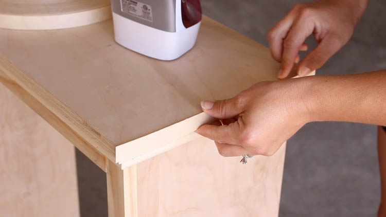 Ironing veneer edge banding onto the plywood cabinet top