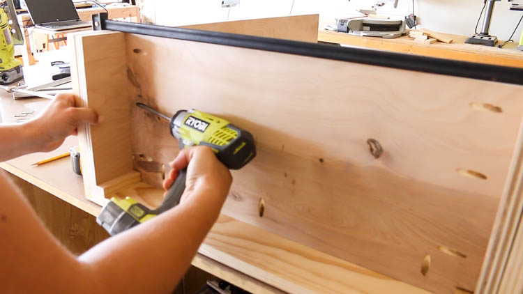 Driving pocket screws to secure the cabinet bottom from the underside
