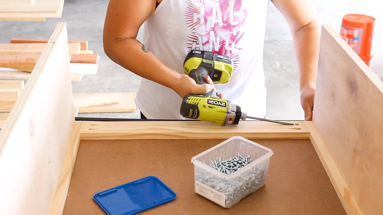 Driving screws to secure the front face frame to the cabinet box
