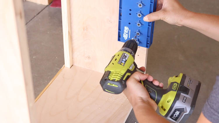 Using a shelf pin jig to drill adjustable shelf holes into the cabinet side