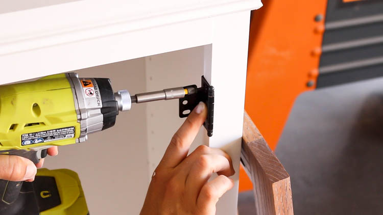 Attaching an inset hinge to the cabinet door with a drill