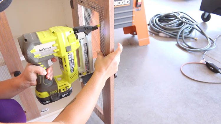 Stapling wire mesh into the back of a cabinet door frame