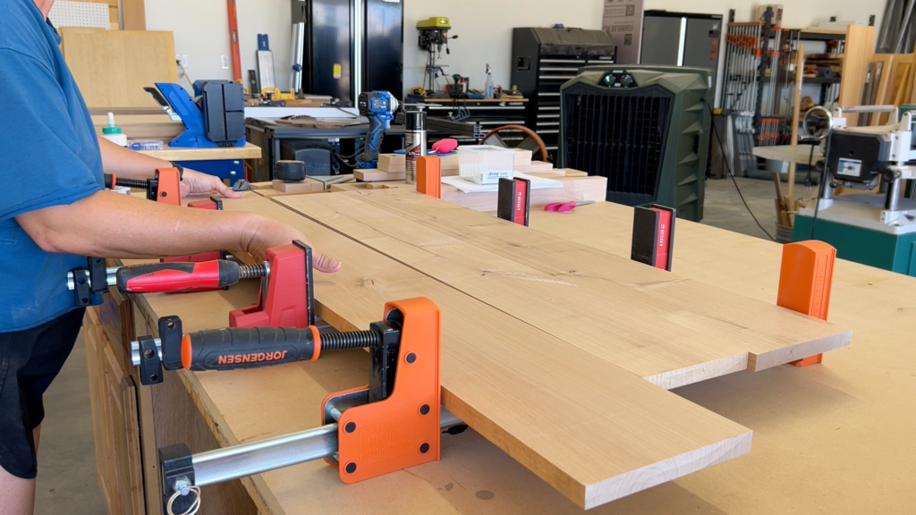 makeup table top being glued up in panel clamps